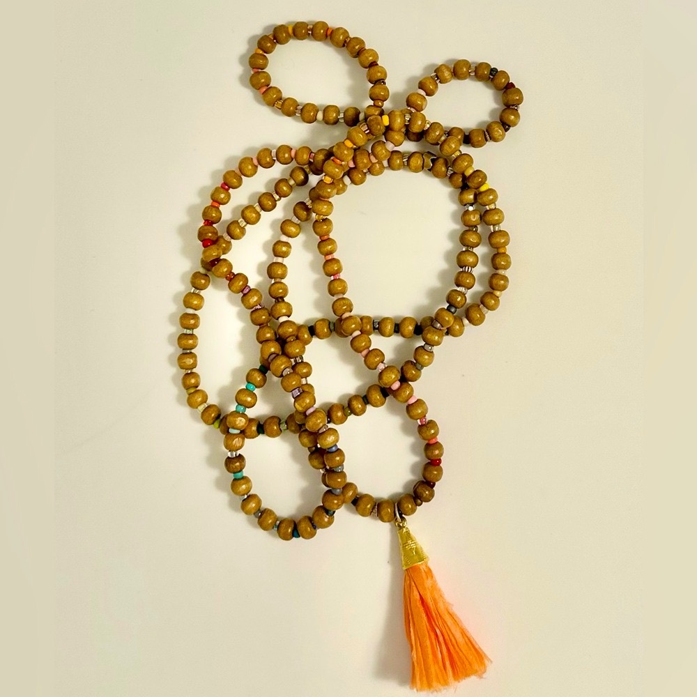 Wood Mala type silk tassel necklace with tiny glass alternating beads.